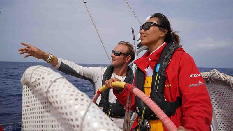 Zhang Shan at the helm of Qingdao being coached by Race Skipper Chris Brooks - photo © Clipper Race