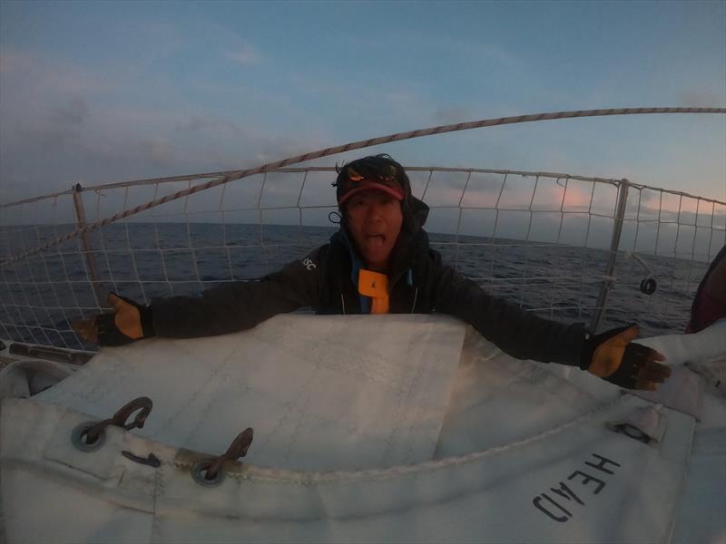 Clipper Race crew Queenie Wang burried in sail - photo © Clipper Race