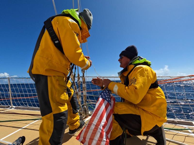 Crew on board Punta del Este hoisting the US flag ready to reach Seattle - Clipper Race - photo © Clipper Ventures