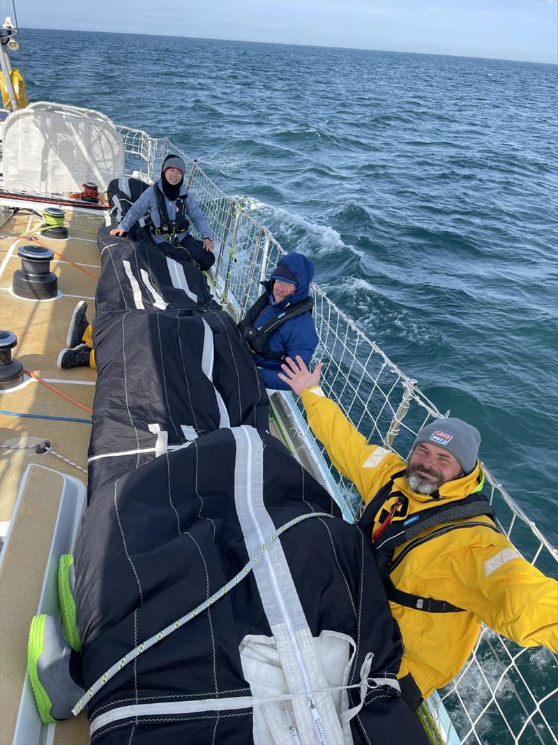 GoToBermuda race crew packing away sails after crossing the finish line - Clipper Race - photo © Clipper Race