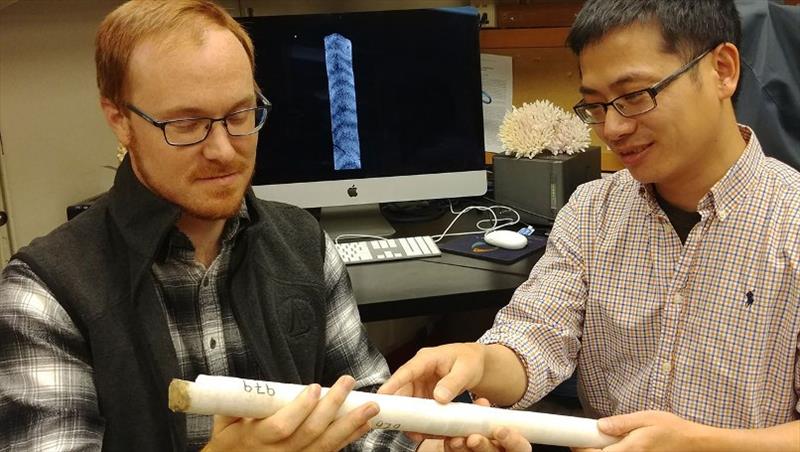 WHOI scientists Nathaniel Mollica (left) and Weifu Guo examine a core extracted from a coral skeleton. In a new study published in the Proceedings of the National Academy of Sciences, they showed how ocean acidification affects coral skeletal growth - photo © Anne Cohen Lab, WHOI