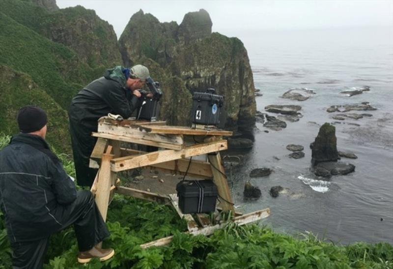 Alaska Ecosystem Program biologists work on retrieving memory cards full of images captured in the past year and performing maintenance on remote cameras stationed high on the cliffs above the Steller sea lion rookery on Cape Sabak on Agattu Island photo copyright NOAA Fisheries taken at  and featuring the Cruising Yacht class