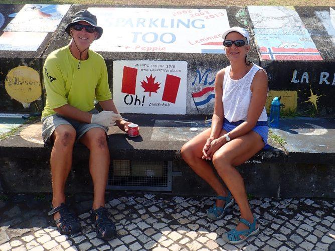 Diane and Rod putting the finishing touches on our mural at the port wall in Horta, Faial, Açores. - photo © Rod Morris