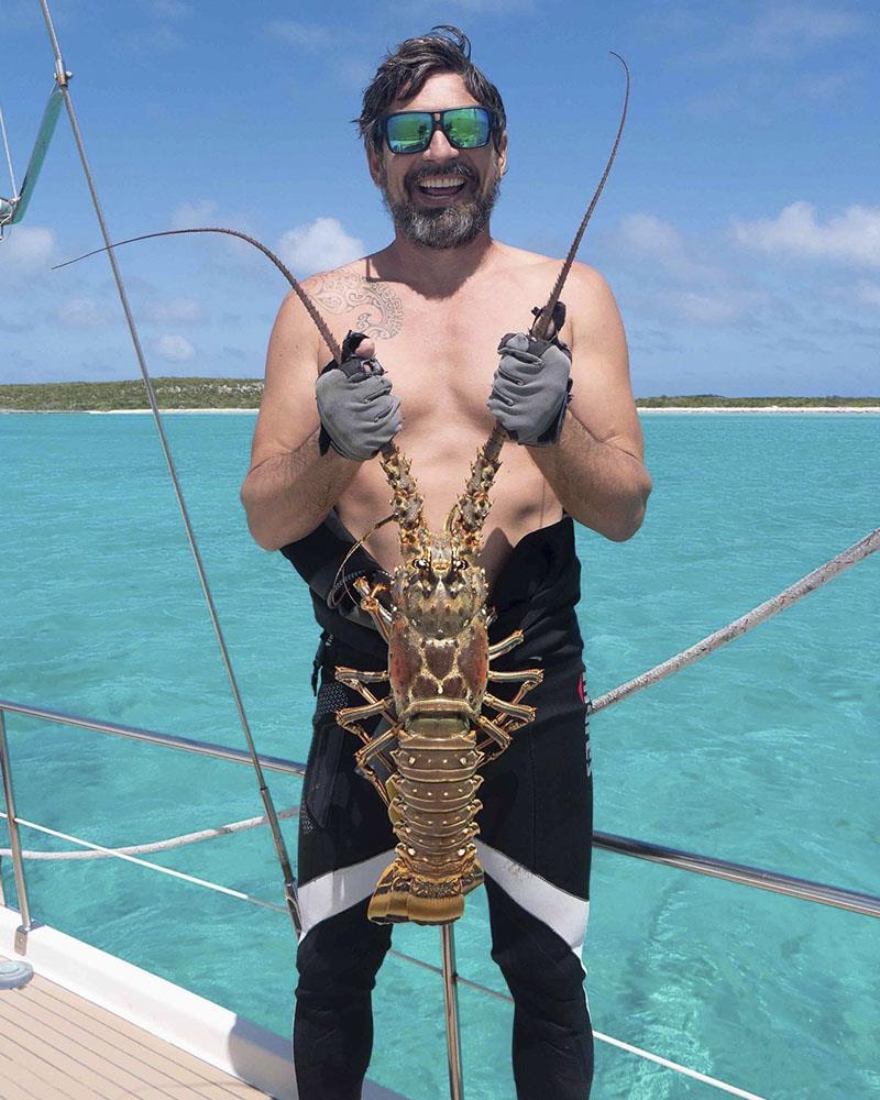 Brian with the day's catch photo copyright SV Delos taken at  and featuring the Cruising Yacht class