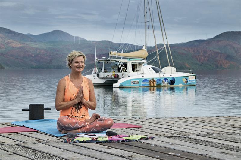 Leanne on the dock in New Caledonia our boat Songlines in background Down Under Rally 'Go East Rally' photo copyright Leanne Hembrow taken at  and featuring the Cruising Yacht class