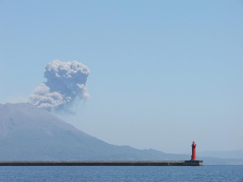 The breakwater at Kagoshima, Sakurajima volcano in eruption - photo © Nick and Jenny Coghlan - s/v Bosun Bird