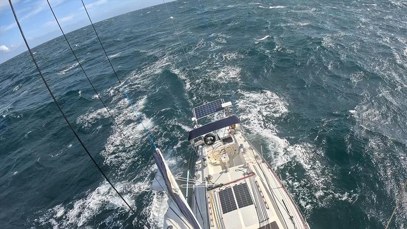 Climbing the mast to retrieve the main halyard - Blue Moon II circumnavigation - photo © Tristan Gourlay