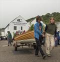 Boat Building Academy students launch their boats in Lyme Regis