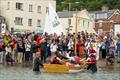 Boat Building Academy students launch their boats in Lyme Regis