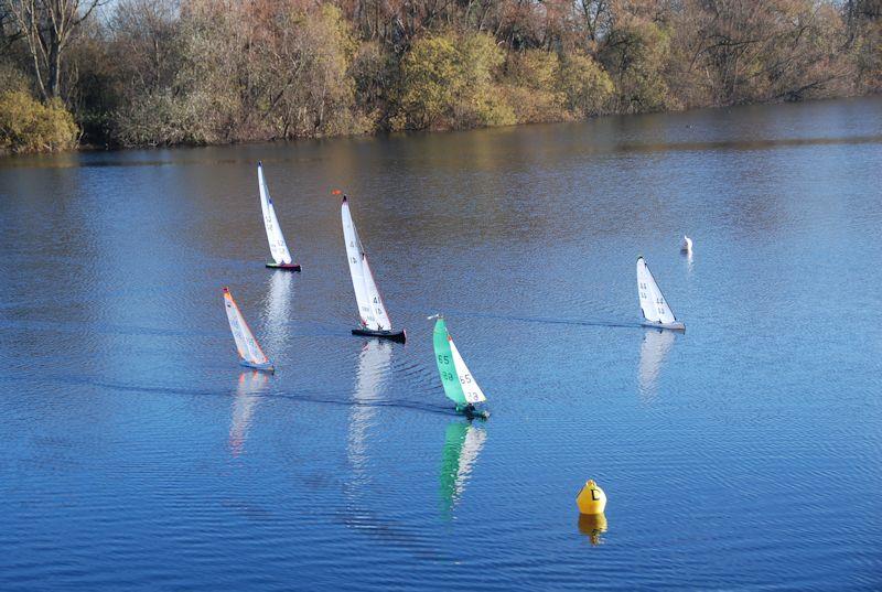 The small boats leading Rob Vice's Marblehead over the line - Marblehead Brass Monkey and GAMES 13 event at Abbey Meads, Chertsey photo copyright Slieve Mcgalliard taken at Guildford Model Yacht Club and featuring the DF95 class