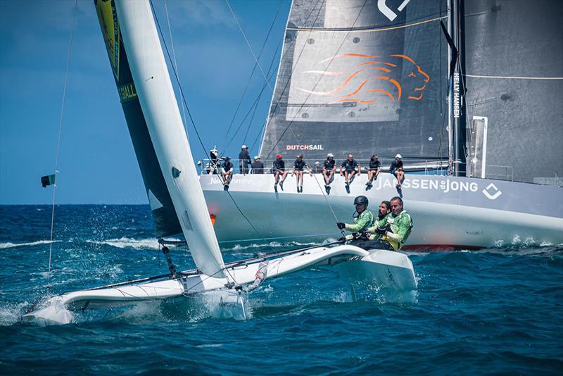 Diam24 Karibuni blasts past VO65 Janssen de Jong on the windward side of St. Maarten in the final leg of the Around the Island Race at the 2022 St. Maarten Heineken Regatta - photo © Laurens Morel