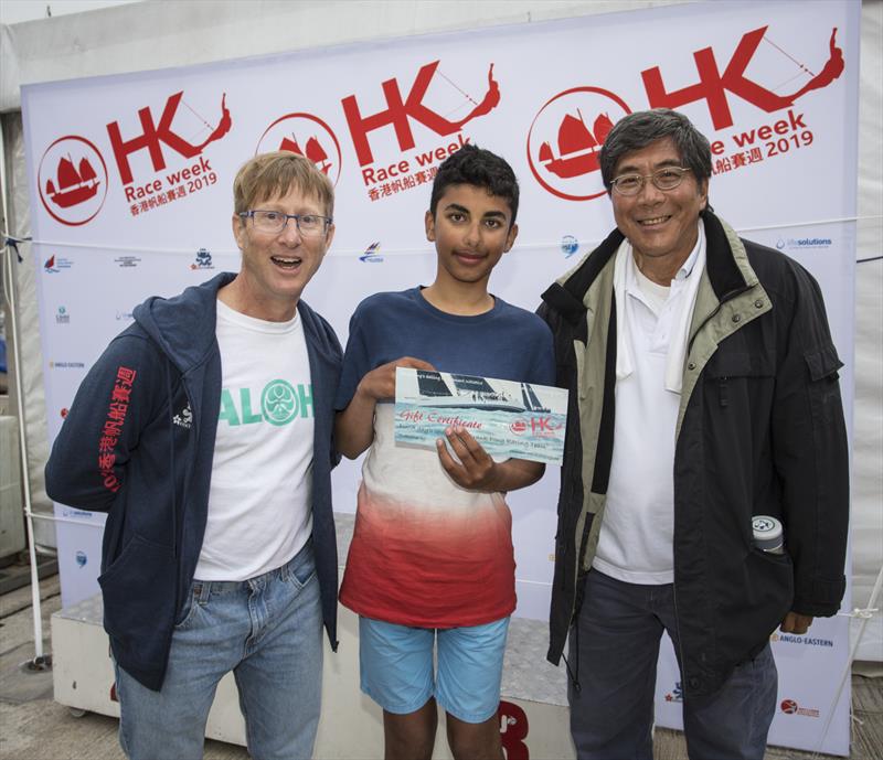 Peter Davies, Regatta Chair, congratulates Shaan Mutreja on winning a ride with Frank Pong (right) on Jelik. Hong Kong Raceweek 2019 photo copyright RHKYC / Guy Nowell taken at Royal Hong Kong Yacht Club and featuring the Dinghy class