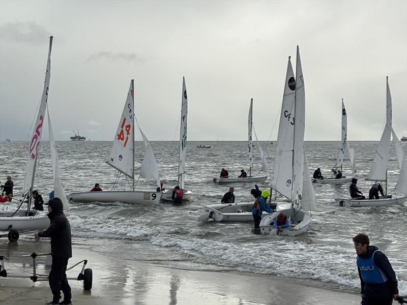 CFJ's launch through the mild surf inside Long Beach Harbor. Each team sailed two races and then came back to the beach to rotate boats - photo © United States Sailing Center