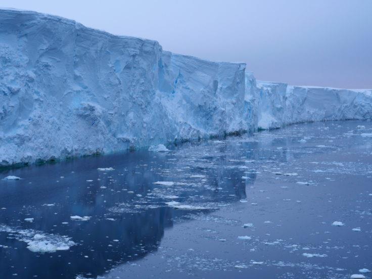 Thwaites ice cliff. The glacier currently contributes four percent of annual global sea level rise photo copyright Rob Larter, BAS taken at  and featuring the Environment class