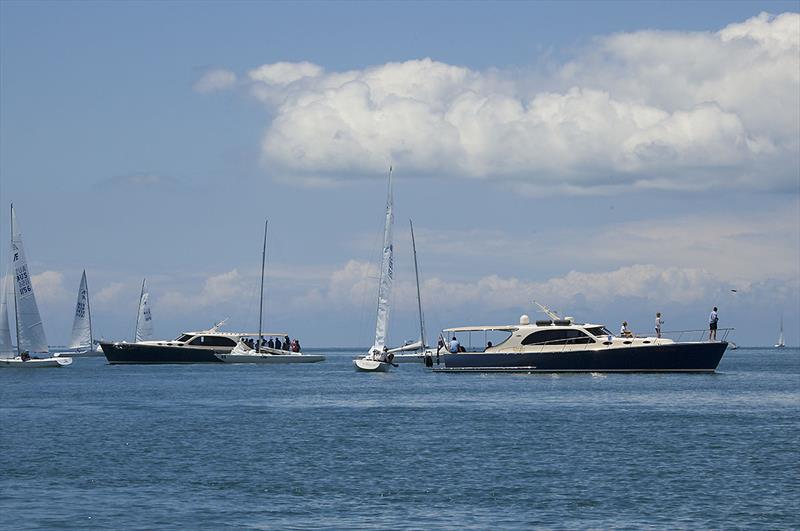 Crews return to their craft from their Palm Beach Motherships as the breeze finally kicks in at the 2018 Etchells World Championship. - photo © John Curnow