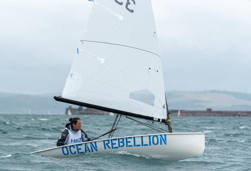 Laura Baldwin carrying an important message on Day 1 at the 2021 UK Europe National Championships photo copyright Linus Etchingham taken at Weymouth & Portland Sailing Academy and featuring the Europe class