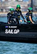 Tom Slingsby, driver of BONDS Flying Roos SailGP Team, takes the wheel of the F50 catamaran alongside Chris Draper, wing trimmer of BONDS Flying Roos SailGP Team, during a practice session ahead of the Emirates Great Britain Sail Grand Prix