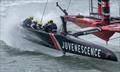 Giles Scott, driver of NORTHSTAR SailGP Team, controls the wheel as waves crash into the F50 catamaran whilst in action on Race Day 2 of the ITM New Zealand Sail Grand Prix in Auckland, New Zealand