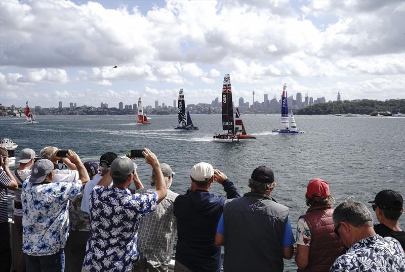 Spectators watch the action from a spectator boat as Great Britain SailGP Team helmed by Ben Ainslie lead the fleet in the first race on Race Day 1 - Sydney SailGP photo copyright Thomas Lovelock for SailGP taken at  and featuring the F50 class