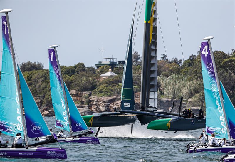 Australia SailGP Team helmed by Tom Slingsby sails close to young sailors in the SailGP Inspire program as they warm up before racing on Race Day 1.- SailGP - Sydney - Season 2 - February 2020 - Sydney, Australia. - photo © Craig Greenhill/SailGP