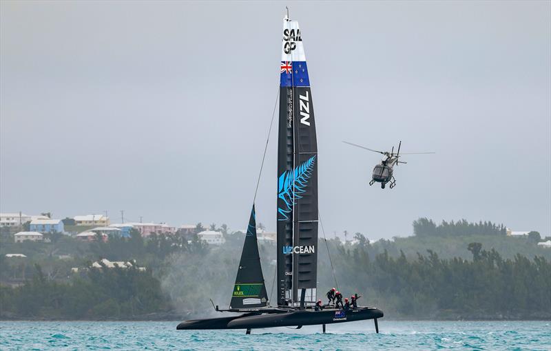 A helicopter comes up behind New Zealand SailGP Team helmed by Peter Burling during a practice session ahead of Bermuda SailGP - photo © Simon Bruty/SailGP
