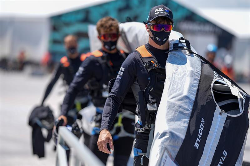 The New Zealand SailGP Team carry their Doyle Sails to the F50 catamaran in the Taranto Technical Area ahead of a practice session photo copyright Thomas Lovelock / SailGP taken at  and featuring the F50 class