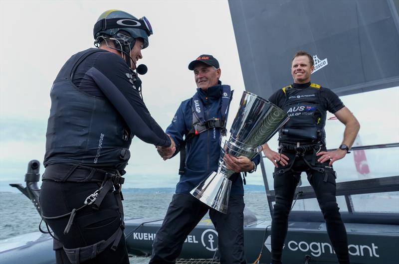 Sir Russell Coutts, SailGP CEO hands the trophy to Tom Slingsby, CEO and driver of Australia SailGP Team as they celebrate their victory in the Grand Final on board their F50 on Race Day 2 of San Francisco SailGP, Season 2  photo copyright Thomas Lovelock/SailGP taken at Golden Gate Yacht Club and featuring the F50 class