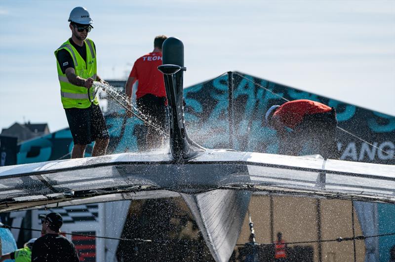 Crew member clean a F50 catamaran at the Technical Base after a practice session ahead of the Great Britain Sail Grand Prix | Plymouth in Plymouth, England. 29th July 2022 - photo © Jon Super/SailGP