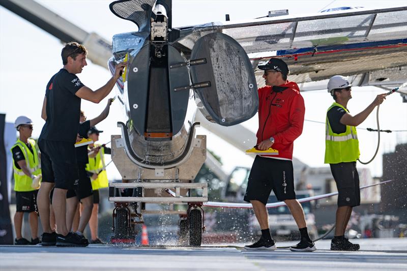 Crew members clean a F50 catamaran at the Technical Base after a practice session ahead of the Great Britain Sail Grand Prix | Plymouth in Plymouth, England. 29th July 2022 - photo © Ricardo Pinto/SailGP