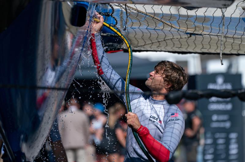 Hans Henken, flight controller of USA SailGP Team, cleans the USA SailGP Team F50 catamaran at the Technical Base after a practice session ahead of the Great Britain Sail Grand Prix | Plymouth in Plymouth, England. 29th July 2022 photo copyright Jon Super/SailGP taken at Royal Plymouth Corinthian Yacht Club and featuring the F50 class