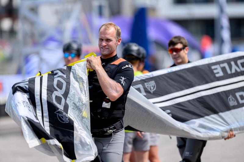 Josh Junior, grinder of New Zealand SailGP Team, carries the teams Doyle Sails across the Technical Base ahead of the Great Britain Sail Grand Prix | Plymouth in Plymouth, England. 28th July 2022 - photo © Jon Buckle/SailGP