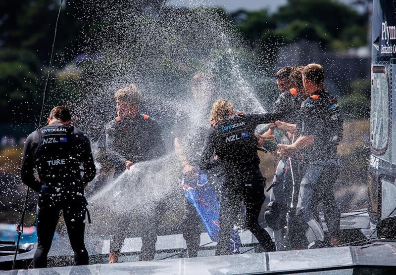 New Zealand SailGP Team spray Champagne Barons de Rothschild as they celebrate winning the Great Britain Sail Grand Prix | Plymouth in Plymouth, England. 31st July 2022.  - photo © David Gray/SailGP