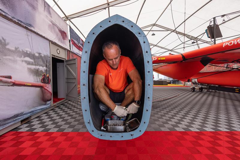 A member of the SailGP Technical team prepares the bow of the Spain SailGP Team F50 catamaran in the teams hangar at the Technical Base ahead of the  Denmark Sail Grand Prix in Copenhagen, Denmark. 16th August  photo copyright David Gray/SailGP taken at Royal Danish Yacht Club and featuring the F50 class