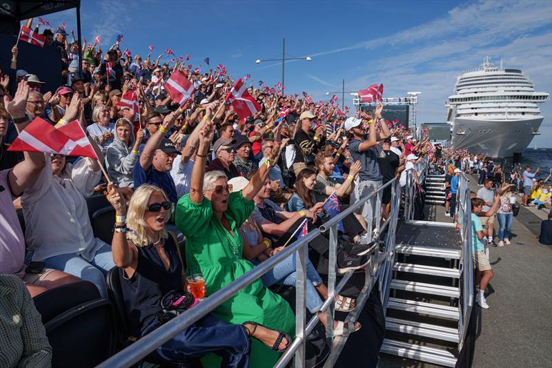 Spectators wave Denmark flags while watching the action from the Race Village next to a cruise ship on Race Day 2 of the Denmark Sail Grand Prix in Copenhagen - photo © Jon Super/SailGP