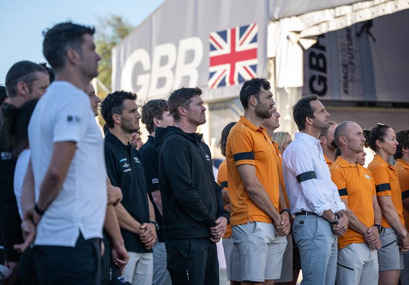 Tom Slingsby, Blair Tuke, Matt Gotrel, grinder of Great Britain SailGP Team, and Ben Ainslie, driver of Great Britain SailGP Team, as the Union flag is lowered to half-mast - photo © Jon Buckle/SailGP