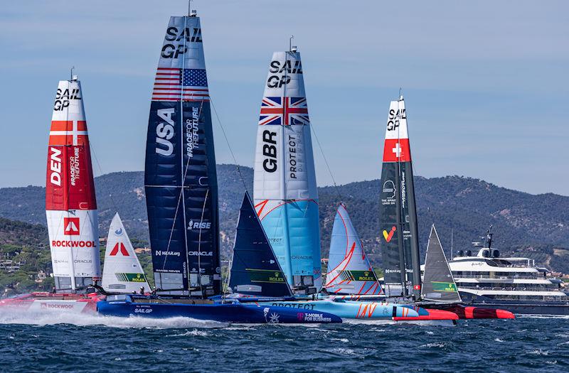 Denmark SailGP Team presented by ROCKWOOL, USA SailGP Team, Great Britain SailGP Team, and Switzerland SailGP Team sail past the superyacht Here Comes The Sun on Race Day 1 of the Range Rover France Sail Grand Prix in Saint Tropez, France - photo © David Gray for SailGP