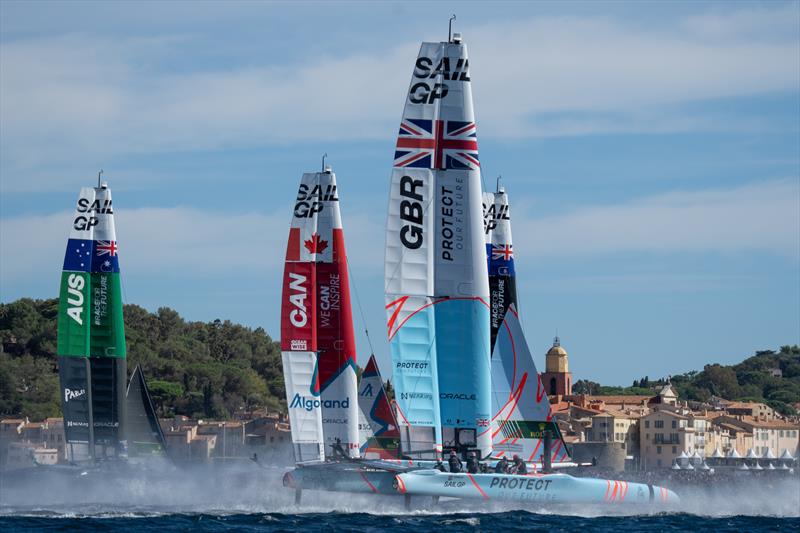 Australia SailGP Team, Canada SailGP Team, and Great Britain SailGP Team sails past the bell tower and old town of Saint Tropez on Race Day 1 of the Range Rover France Sail Grand Prix in Saint Tropez, France photo copyright Bob Martin for SailGP taken at  and featuring the F50 class