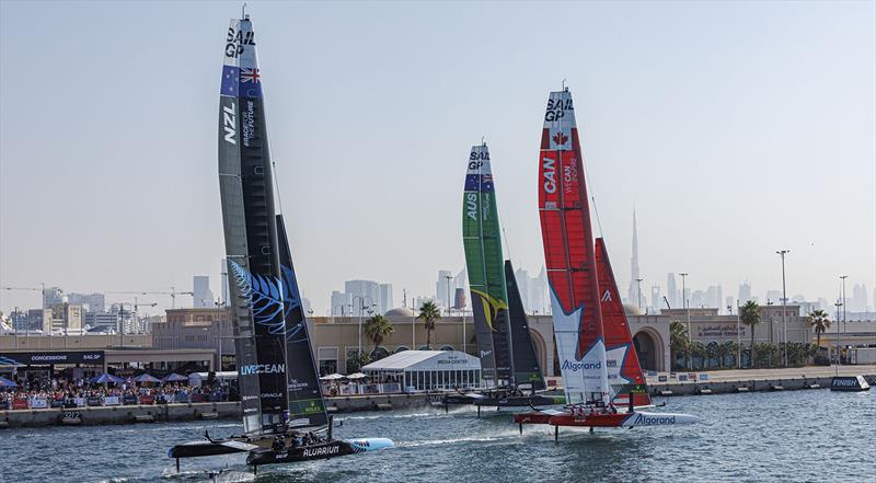 New Zealand SailGP Team helmed by Peter Burling, Australia SailGP Team helmed by Tom Slingsby and Canada SailGP Team helmed by Phil Robertson in action as they sail closely past the Race Village on Race Day 1 of the Dubai Sail Grand Prix presented by P&O  photo copyright David Gray for SailGP taken at Dubai Offshore Sailing Club and featuring the F50 class