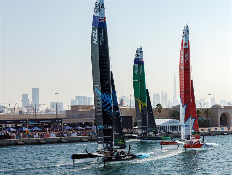 New Zealand SailGP Team helmed by Peter Burling, Australia SailGP Team helmed by Tom Slingsby and Canada SailGP Team helmed by Phil Robertson in action as they sail closely past the Race Village at the Dubai Sail Grand Prix presented by P&O Marinas photo copyright David Gray for SailGP taken at  and featuring the F50 class