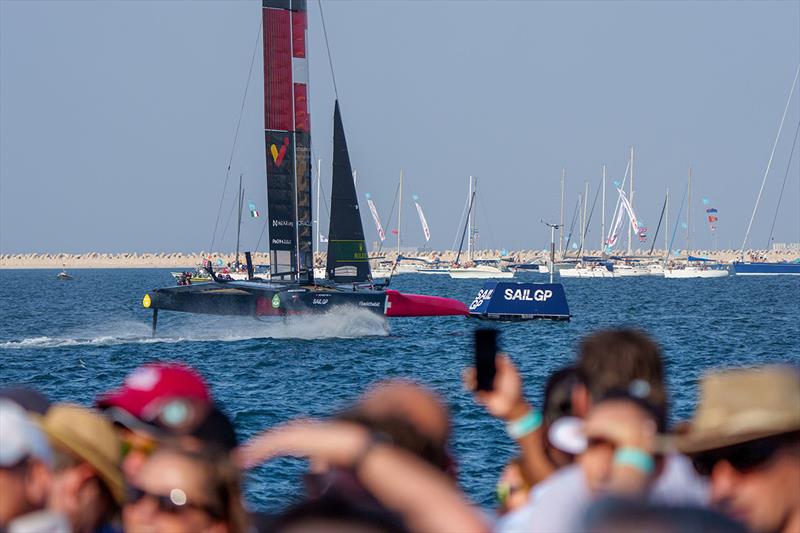 Spectators watch on as Switzerland SailGP Team helmed by Sebastien Schneiter sail closely past the Race Village on Race Day 2 of the Dubai Sail Grand Prix  photo copyright Joe Toth for SailGP taken at  and featuring the F50 class
