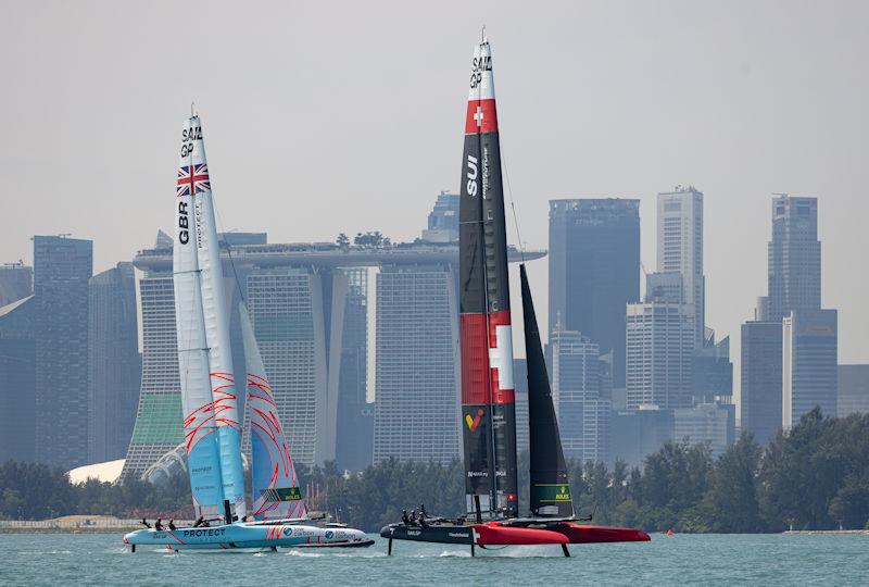 Great Britain SailGP Team and Switzerland SailGP Team sail past the Marina Bay Sands Hotel ahead of the Singapore Sail Grand Prix presented by the Singapore Tourism Board - photo © Felix Diemer for SailGP
