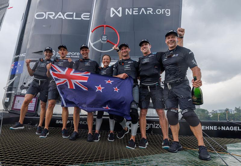 The New Zealand SailGP Team crew celebrate their win on their F50 with Champagne Barons de Rothschild and their national flag on Race Day 2 of the Singapore Sail Grand Prix presented by the Singapore Tourism Board - photo © Felix Diemer for SailGP
