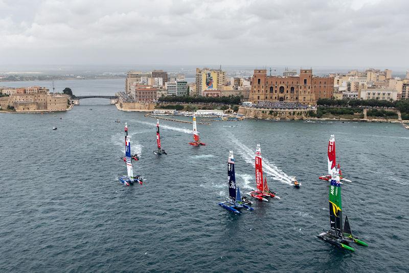 The SailGP Fleet led by Australia SailGP Team helmed by Tom Slingsby sail past the town of Taranto on Race Day 1 of the ROCKWOOL Italy Sail Grand Prix in Taranto, Italy photo copyright Ricardo Pinto for SailGP taken at  and featuring the F50 class