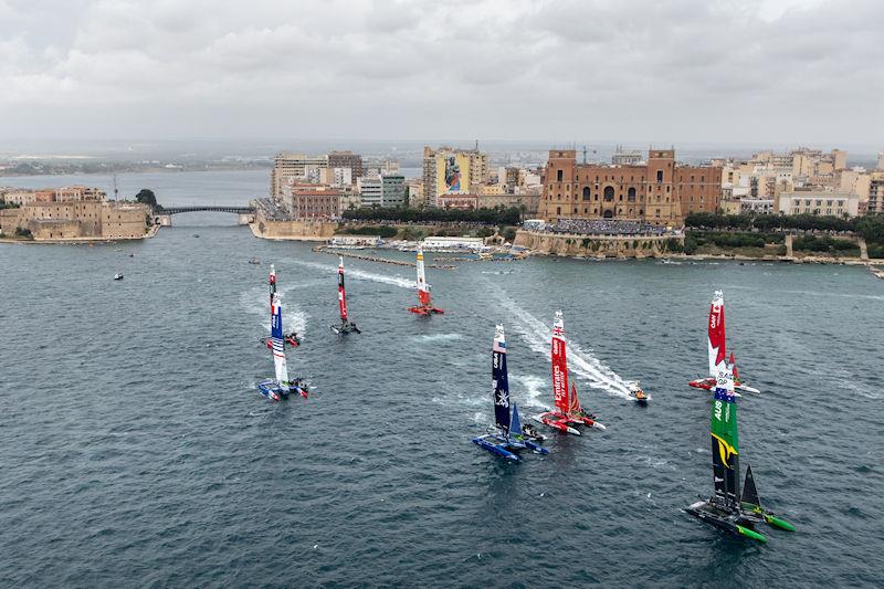 The SailGP Fleet led by Australia SailGP Team helmed by Tom Slingsby sail past the town of Taranto on Race Day 1 of the ROCKWOOL Italy Sail Grand Prix in Taranto, Italy - photo © Ricardo Pinto for SailGP