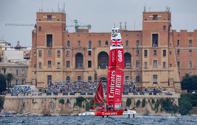 Emirates Great Britain SailGP Team helmed by Ben Ainslie ail past the Taranto Palazzo del Governo and the SailGP Race Stadium on Race Day 1 of the ROCKWOOL Italy Sail Grand Prix in Taranto, Italy - photo © Bob Martin for SailGP