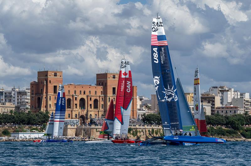 France SailGP Team, Canada SailGP Team, USA SailGP Team and Spain SailGP Team sail past the SailGP Race Stadium and Taranto Palazzo del Governo on Race Day 2 of the ROCKWOOL Italy Sail Grand Prix in Taranto, Italy photo copyright Bob Martin for SailGP taken at  and featuring the F50 class