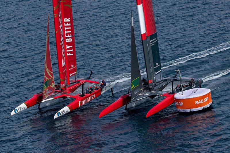Tight racing action between Emirates Great Britain SailGP Team helmed by Ben Ainslie and Switzerland SailGP Team helmed by Sebastien Schneiter as they sail around a course marker during a practice session ahead of the ROCKWOOL Italy Sail Grand Prix - photo © Felix Diemer for SailGP