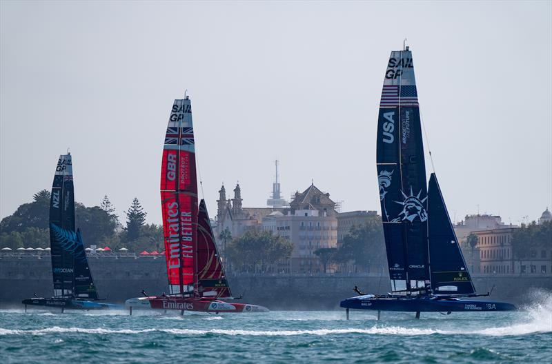USA SailGP Team helmed by Jimmy Spithill ahead of Emirates Great Britain SailGP Team and New Zealand SailGP Team sail past the seawall during a practice session ahead of the Spain Sail Grand Prix in Cadiz, Spain - photo © Bob Martin for SailGP