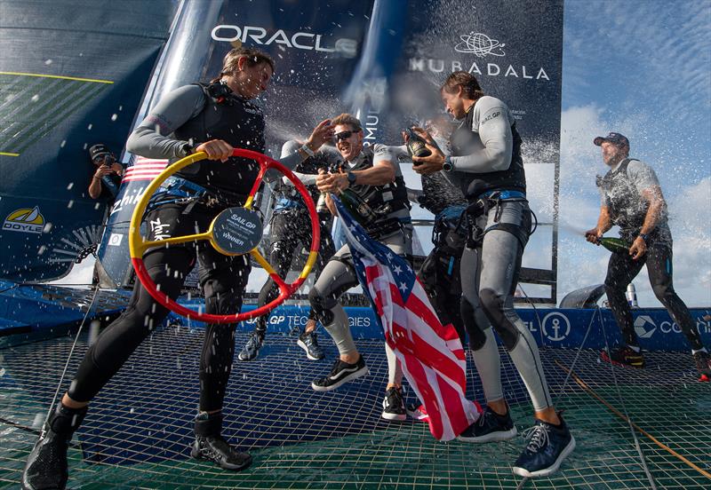 Peter Kinney, grinder of USA SailGP Team, sprays Barons De Rothschild Champagne on Erika Reineke, strategist of USA SailGP Team, as USA SailGP Team celebrate onboard after winning the Spain Sail Grand Prix in Cadiz, Spain photo copyright Ricardo Pinto for SailGP taken at  and featuring the F50 class