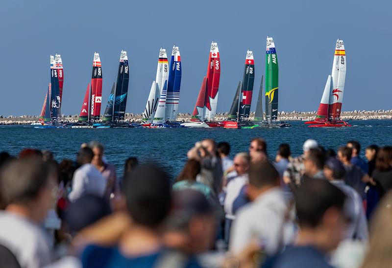The fleet in action with the crowd watching on from the Race Stadium in the foreground on Race Day 2 of the Emirates Sail Grand Prix presented by P&O Marinas in Dubai, United Arab Emirates - photo © Kieran Cleeves for SailGP